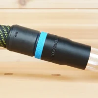 Black hose adapter with blue band attached to Kreg 20v trim router, connected to braided hose
