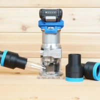 Black 1-7/8 inch hose adapter with blue cuff beside a Kreg 20v trim router and connected vacuum hose