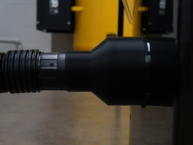 Black hose adapter with threaded inlet and elbow outlet, shown from the side in profile