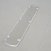 Clear acrylic zero clearance insert for DeWalt 12" miter saw, shown from above with mounting tabs visible along edges