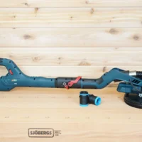 Two black 1-1/4 inch hose adapters with blue rings resting beside a Bosch 9in drywall sander on a bench