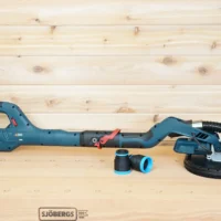 Bosch 9in drywall sander on a workbench with a black and blue 36mm ToolCurve hose adapter, one attached to the green hose and two loose