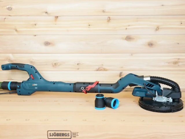 Bosch 9in drywall sander on a workbench with a black and blue 36mm ToolCurve hose adapter, one attached to the green hose and two loose