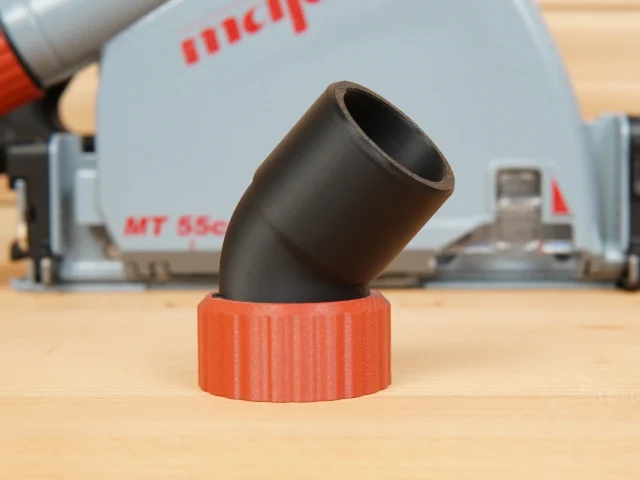 Red 3D-printed dust port adapter with black hose connector angled upward, shown standalone on wood surface