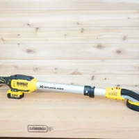 Yellow 36mm hose adapter joining a green extractor hose to the dust port of a DeWalt 20V Max drywall sander