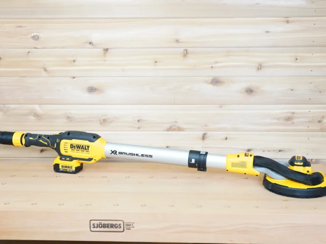 Yellow 36mm hose adapter joining a green extractor hose to the dust port of a DeWalt 20V Max drywall sander