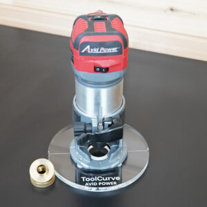 Clear 6 inch round acrylic base plate, guide bushing version, mounted on a red Avid Power trim router with a brass guide bushing beside it