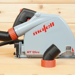 No Snag dust port with red twist-lock collar installed on a Mafell MT 55cc track saw, angling the hose upward, with a spare adapter in front
