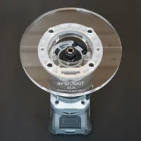 6 inch round clear acrylic router base plate mounted on Flex trim router, showing wide cut opening and central brass bushing nut