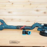 Two black and blue 1-7/8 inch hose adapters on a workbench beside a Bosch 9in drywall sander, one fitted to the vac hose