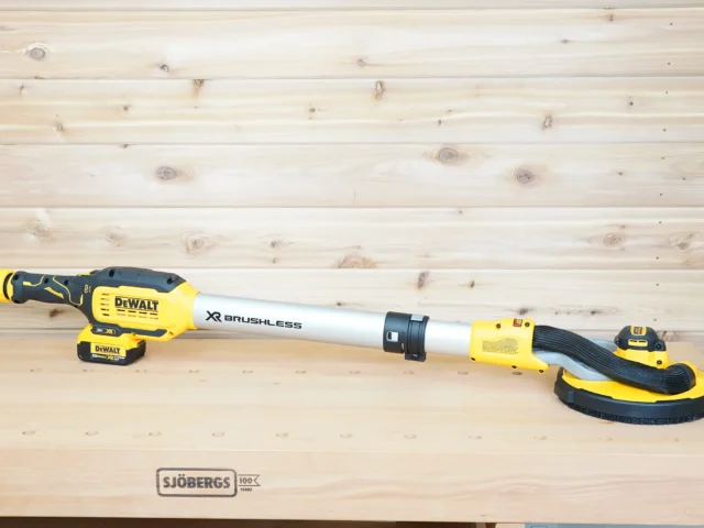 Dewalt 20v Max 9in drywall sander on a workbench with a 1-7/8 inch hose adapter fitted to its dust port