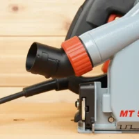 No Snag Dust Port adapter attached to a Mafell MT 55cc track saw, with the angled black port and red twist-lock connector directing the hose upward away from the cutting area.