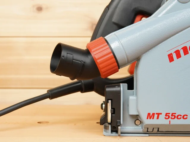 No Snag Dust Port adapter attached to a Mafell MT 55cc track saw, with the angled black port and red twist-lock connector directing the hose upward away from the cutting area.
