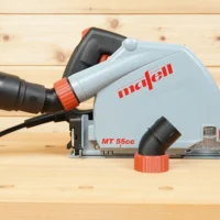 No Snag Dust Port adapter attached to Mafell MT 55cc track saw, with hose routed upward at an angle