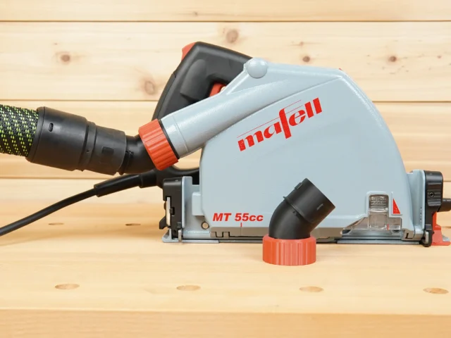 No Snag Dust Port adapter attached to Mafell MT 55cc track saw, with hose routed upward at an angle