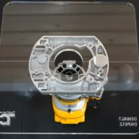 10-inch square clear acrylic base plate mounted on DeWalt DNP612 plunge router base, viewed from above in packaging