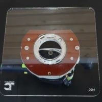 10-inch square clear acrylic base plate with reddish-brown mounting ring and circular opening, attached to Festool OF 1400 router from above