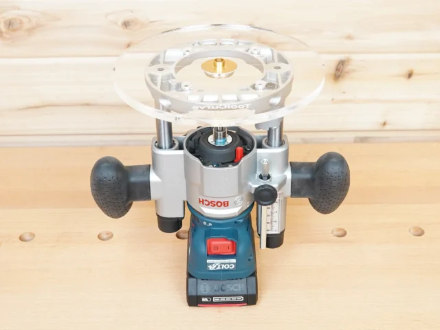 8-inch clear acrylic router base plate mounted on a Bosch plunge router, top and front view on wood workbench