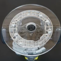 Clear acrylic round base plate with 8-inch diameter, mounted on Ryobi 1-1/2" router, viewed from above showing center spindle hole and eight mounting holes