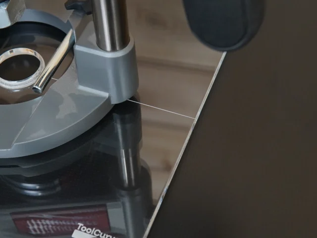Clear acrylic 10-inch square base plate attached to Milwaukee M18 router, showing smooth underside and mounting interface