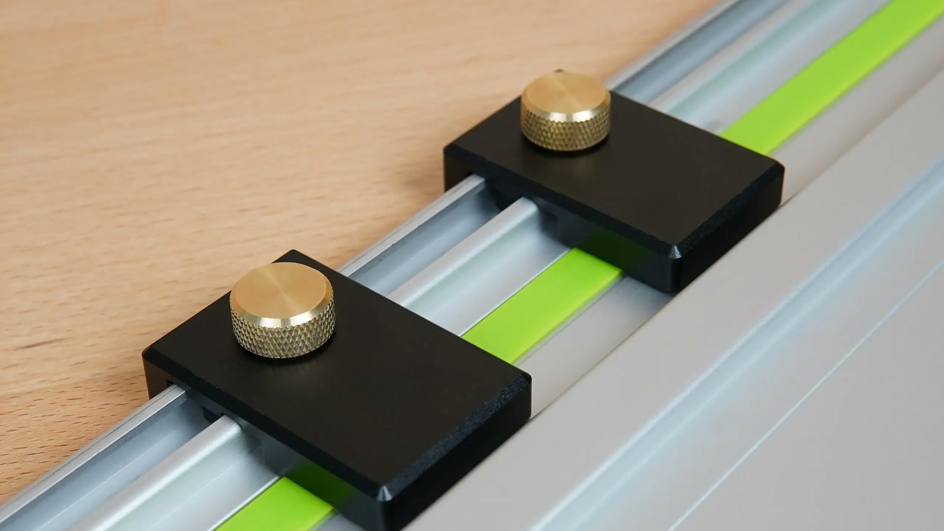 Two ToolCurve guide rail limit stops secured to a track saw rail
