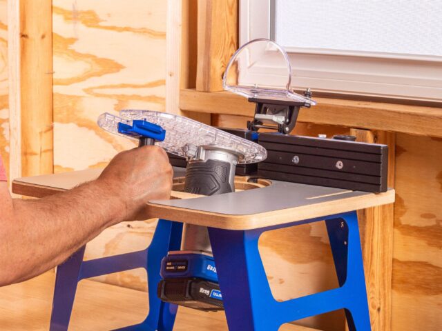 Kreg Dock & Go trim router table with its clear router plate being moved between handheld and table use