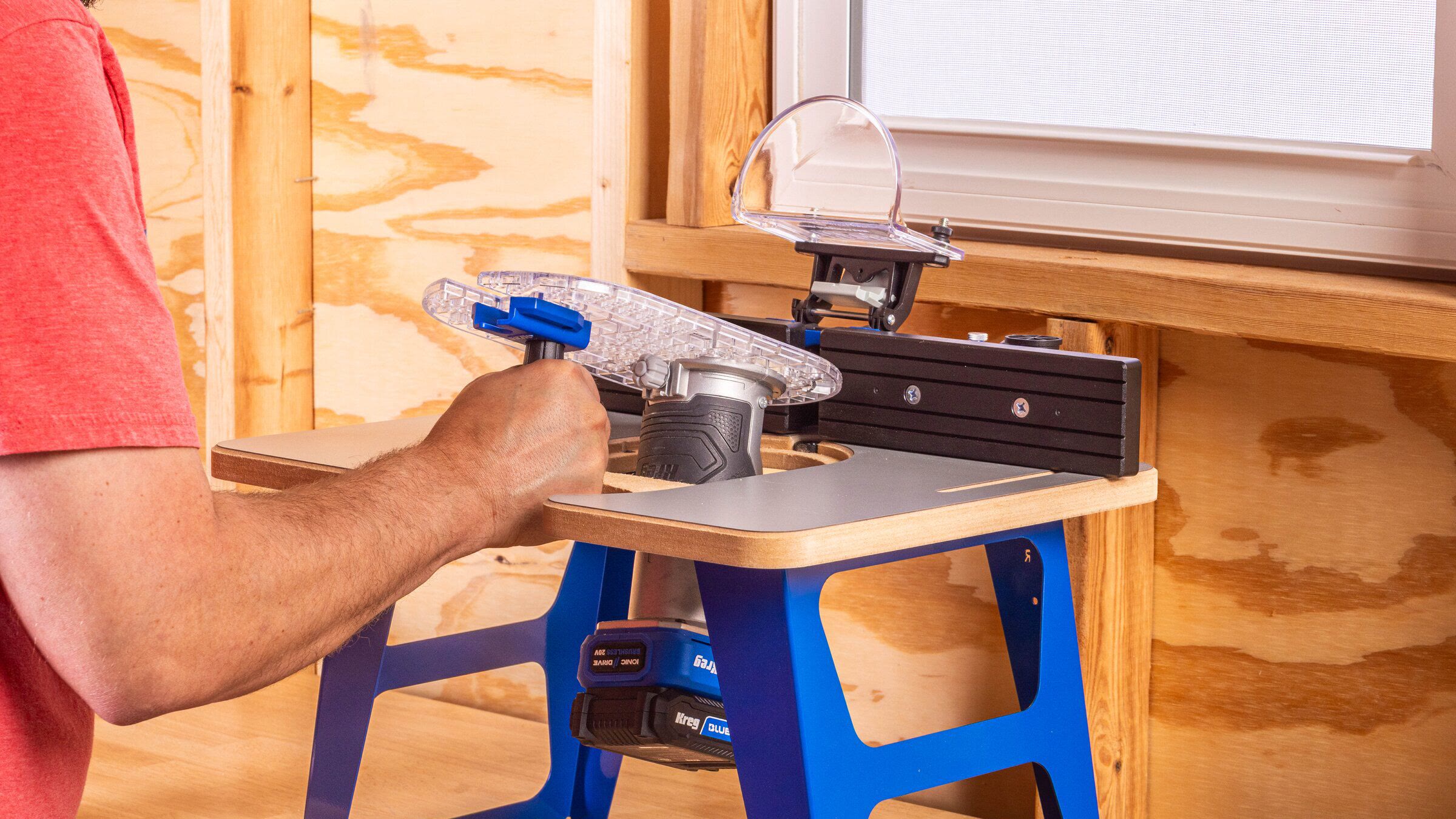 Kreg Dock & Go trim router table with its clear router plate being moved between handheld and table use