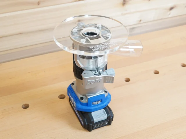 Kreg 20V trim router fitted with a clear 6-inch ToolCurve acrylic base plate on a workbench